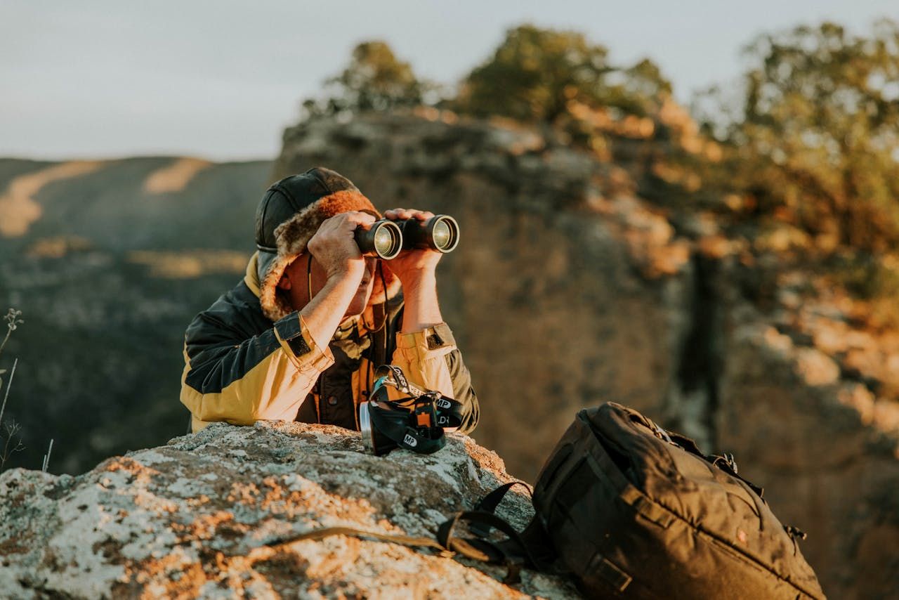 man using his binoculars